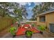 Cozy backyard patio with red mulch and potted plants at 1415 Mohrlake Dr, Brandon, FL 33511