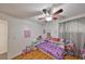 Light and airy bedroom with a ceiling fan and hardwood floors at 1415 Mohrlake Dr, Brandon, FL 33511