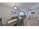 Dining room with gray chairs and a wood table, open to the living room at 1415 Mohrlake Dr, Brandon, FL 33511