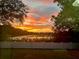 Scenic sunset view over a tranquil lake from the backyard at 1415 Mohrlake Dr, Brandon, FL 33511