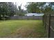 Spacious backyard with a grassy lawn and wooden fence at 1601 Essex N Dr, St Petersburg, FL 33710