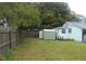 Backyard view showing a wooden fence and storage shed at 1601 Essex N Dr, St Petersburg, FL 33710