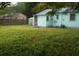 Large backyard with grassy area and a view of a neighboring house at 1601 Essex N Dr, St Petersburg, FL 33710