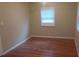 Simple bedroom with hardwood floors and a window at 1601 Essex N Dr, St Petersburg, FL 33710