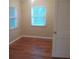 Bright bedroom with hardwood floors and two windows at 1601 Essex N Dr, St Petersburg, FL 33710