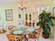 Charming dining area with a round glass table and wicker chairs at 1701 Pinehurst Rd # 8B, Dunedin, FL 34698