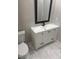 Modern bathroom with white vanity, black fixtures, and marble-look tile at 1751 Yale S St, St Petersburg, FL 33711