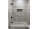 Clean bathroom with marble-look shower surround and white fixtures at 1751 Yale S St, St Petersburg, FL 33711