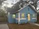 Charming bungalow with light blue siding, yellow door, and landscaping at 1751 Yale S St, St Petersburg, FL 33711