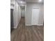 Bright hallway with wood-look flooring and neutral-toned walls at 1751 Yale S St, St Petersburg, FL 33711