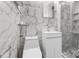 Modern bathroom with marble tile, white vanity, and glass shower at 1807 W Crawford St, Tampa, FL 33604