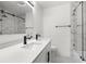 Bathroom boasts double vanity, marble shower, and shiplap feature wall at 1807 W Crawford St, Tampa, FL 33604