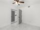 Bedroom with mirrored closet doors and ceiling fan at 1807 W Crawford St, Tampa, FL 33604