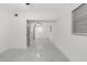 Long hallway with marble-look tile floors and access to bedrooms at 1807 W Crawford St, Tampa, FL 33604