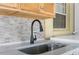 Outdoor kitchen sink with black faucet and stone countertop at 1807 W Crawford St, Tampa, FL 33604