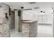 Stylish wet bar featuring a stone backsplash and wooden shelving at 1807 W Crawford St, Tampa, FL 33604