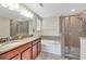 Bathroom with granite double vanity, soaking tub and shower at 1966 Hawks View Dr, Ruskin, FL 33570