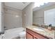 Clean bathroom featuring a tub, shower, granite vanity, and updated fixtures at 1966 Hawks View Dr, Ruskin, FL 33570