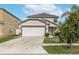 Two-story house with attached garage, landscaping, and a driveway at 1966 Hawks View Dr, Ruskin, FL 33570