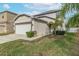 Two-story house with attached garage and well-manicured lawn at 1966 Hawks View Dr, Ruskin, FL 33570