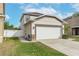 Two-story house with attached garage and side yard access at 1966 Hawks View Dr, Ruskin, FL 33570