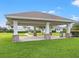 Covered pavilion with stone columns and grassy area at 1966 Hawks View Dr, Ruskin, FL 33570