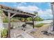 Outdoor patio with pergola, grill, and lighting at 1966 Hawks View Dr, Ruskin, FL 33570