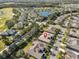 Beautiful aerial view of a suburban neighborhood with lush landscaping and a community pond and golf course at 2124 Sifield Greens Way # 11, Sun City Center, FL 33573