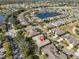 Aerial view of a community with mature trees, a body of water, golf course and houses at 2124 Sifield Greens Way # 11, Sun City Center, FL 33573