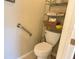 Small bathroom with toilet and shelving unit for storage at 2124 Sifield Greens Way # 11, Sun City Center, FL 33573