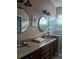 Bathroom featuring a dual-sink vanity with granite countertops at 2124 Sifield Greens Way # 11, Sun City Center, FL 33573