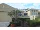 Exterior view of house with two car garage and fenced in patio area at 2124 Sifield Greens Way # 11, Sun City Center, FL 33573