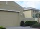 Attached garage providing convenient parking and additional storage space with well manicured landscaping around it at 2124 Sifield Greens Way # 11, Sun City Center, FL 33573