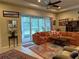 Bright living room with sectional sofa and access to backyard at 2124 Sifield Greens Way # 11, Sun City Center, FL 33573