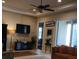 Inviting living room featuring a ceiling fan, recessed lights, tile flooring, and access to lanai through sliding doors at 2124 Sifield Greens Way # 11, Sun City Center, FL 33573