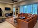 Living room with sectional sofa and access to patio at 2124 Sifield Greens Way # 11, Sun City Center, FL 33573