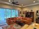 Comfortable living room featuring a spacious seating area and sliding door access to the outdoors at 2124 Sifield Greens Way # 11, Sun City Center, FL 33573