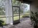 Relaxing screened patio with brick flooring and lush landscaping at 2124 Sifield Greens Way # 11, Sun City Center, FL 33573