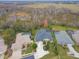 Aerial perspective of a house and surrounding neighborhood near a lake at 2126 Larchwood Ct, Trinity, FL 34655