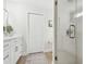 Simple bathroom with a white vanity, glass shower, and linen closet at 2126 Larchwood Ct, Trinity, FL 34655