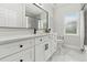 Clean bathroom with a white vanity, marble floor, and large mirror at 2126 Larchwood Ct, Trinity, FL 34655