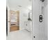 Modern bathroom with a glass shower, white vanity, and hexagonal floor tile at 2126 Larchwood Ct, Trinity, FL 34655