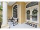 Inviting front porch with rocking chairs and decorative wreaths at 2126 Larchwood Ct, Trinity, FL 34655