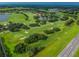 Golf course with fairways, water features, and nearby homes at 2126 Larchwood Ct, Trinity, FL 34655