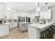 Modern kitchen with white cabinets, quartz countertops, and island at 2126 Larchwood Ct, Trinity, FL 34655