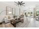 Bright and airy living room with neutral decor and hardwood floors at 2126 Larchwood Ct, Trinity, FL 34655