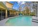 Inviting screened pool with a spacious patio and lush landscaping at 2126 Larchwood Ct, Trinity, FL 34655