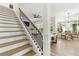 Elegant staircase with a modern iron railing and wooden steps at 2126 Larchwood Ct, Trinity, FL 34655