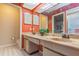 Bathroom with double vanity, tiled floor, and orange walls at 2241 Heron Circle, Clearwater, FL 33762