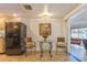 Kitchen breakfast nook with glass table and chairs, black refrigerator at 2241 Heron Circle, Clearwater, FL 33762